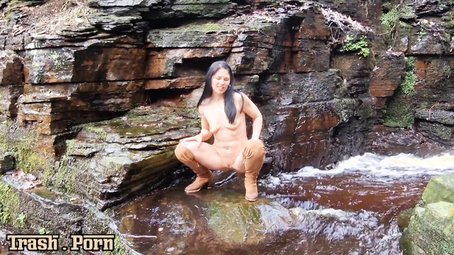 Sexy pissing in suede bootsat the waterfall, enjoy