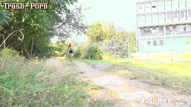 Redhead lady playfully lifted her short dress and peed