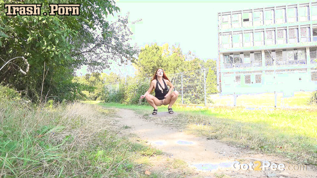 Redhead lady playfully lifted her short dress and peed