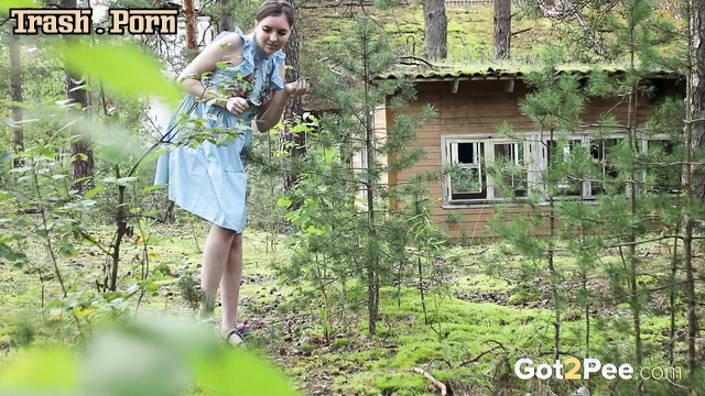 Modest girl sniffed the flowers and then got on all fours and peed