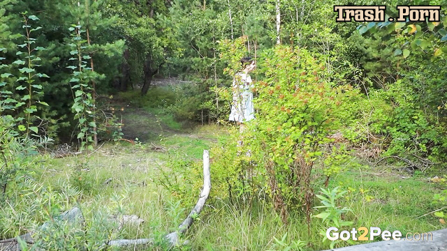 Young brunette moistened a forest log with her urine