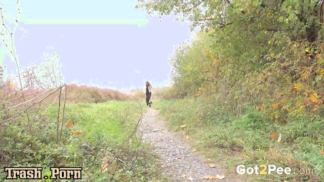 Redhead lady smiling and peeing in nature, solo scene