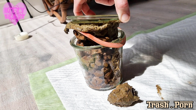 Kitty Skatt took her jar of shit from the shelf and took a shit in it