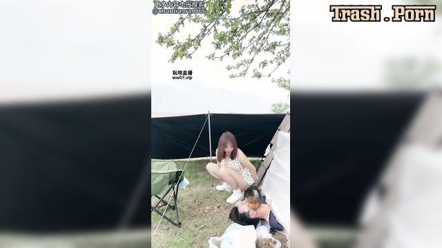 Asian babe smearing shit all over his face near the tent, Mistress Mico